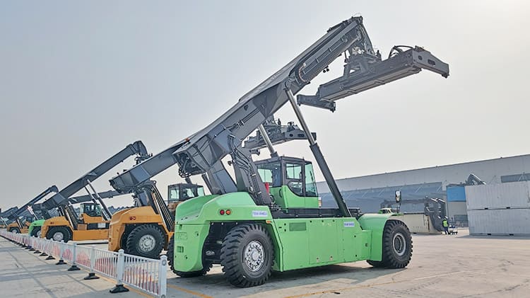 Container Stacker Price: 80000 USD In the landscape of global logistics, reach container stacker have become a key player in container handling operations in Jamaica. Known for the ability to move, lift, and stack containers with both strength and agility, these machines are widely used at ports, rail yards, and logistics terminals. The combination of mobility, lifting capacity, and compact design allows to Jamaica operate efficiently in environments where both time and space are at a premium. Compared with fixed crane systems, container stacker offer a more flexible and cost-effective solution, especially for facilities managing a diverse range of cargo handling needs. Specification of Container Stacker Vehicle Model: XCSE model 45t Motor Model: DM380H46 Rated Power: 200kw Rated Lipting Capacity: 45000kg Max Lifting Height: 15100mm Total Vehicle Curb Weight: 73500kg Max Design Travel Speed: 28km/h Advantage of Reach Container Stacker Central to the container stacker for sale performance is the operator cabin, which is engineered for both comfort and functionality. Visibility is essential in container handling, and the elevated position of the cab, ensures a clear view of the working area. Inside the cab, the controls are arranged for intuitive operation, with joystick systems, display panels, and diagnostic interfaces that allow the operator to monitor the container stacker machine in real time. Good visibility and responsive controls significantly reduce the chances of accidents and improve overall efficiency. The lifting process relies on the reach container stacker crane that can extend and tilt to reach containers placed several rows deep and multiple levels high. Constructed from high strength steel, the crane is designed to withstand heavy-duty use while maintaining smooth, controlled motion. Container stacker is powered by hydraulic cylinders that provide the force required for lifting and reaching, allowing the machine to access containers in tight, confined yards without compromising safety or balance. At the end of the crane is the container spreader, a specialized attachment that locks onto the top corners of a container via twist locks. These spreaders are built to adjust between 20-foot and 40-foot containers and often include sensors and alignment aids to speed up the connection process. The hydraulic system of a container stacker for sale is responsible for most of its movement and control functions. The powers the lifting arm, the spreader, and often the steering system as well. A well-designed hydraulic system ensures consistent performance, allowing the Jamaica operator to perform precise movements with minimal delay. Efficiency here is not only about speed, but also about fuel consumption, as modern hydraulic systems are often optimized to reduce energy loss and improve overall machine longevity. Supporting the structure is a heavy duty chassis that houses the drivetrain, engine, and other critical components. Container stacker machine typically use large pneumatic tires and robust axles to manage rough or uneven surfaces often found in terminal yards. The drive system, usually powered by a high-output diesel engine, delivers the torque needed to move heavy loads across short distances. Safety and monitoring technologies are integrated throughout the system. Load monitoring ensures that the reach container stacker doesn't exceed its capacity, while tire pressure systems (TPMS) provide early warnings of potential issues. In more advanced models, cameras, radar systems, and anti-tip mechanisms enhance safety during complex handling tasks. These systems are designed not only to protect the operator, but also to minimize the risk of damage to cargo or infrastructure. Counterweights form another key part of the container stacker for sale structure. Installed at the rear of the machine, these provide balance when lifting heavy containers at full reach. The weight is carefully calculated based on the container stacker machine lifting capacity and crane geometry. Some models may also include stabilizing legs for additional support when stacking at higher levels or on uneven ground. Reach container stacker continue to play a vital role in modern freight handling, offering a combination of strength, control, and adaptability. By bringing together advanced engineering across every component, from the cabin to the hydraulic system, offer a complete solution for operations in Jamaica that demand speed, safety, and reliability.